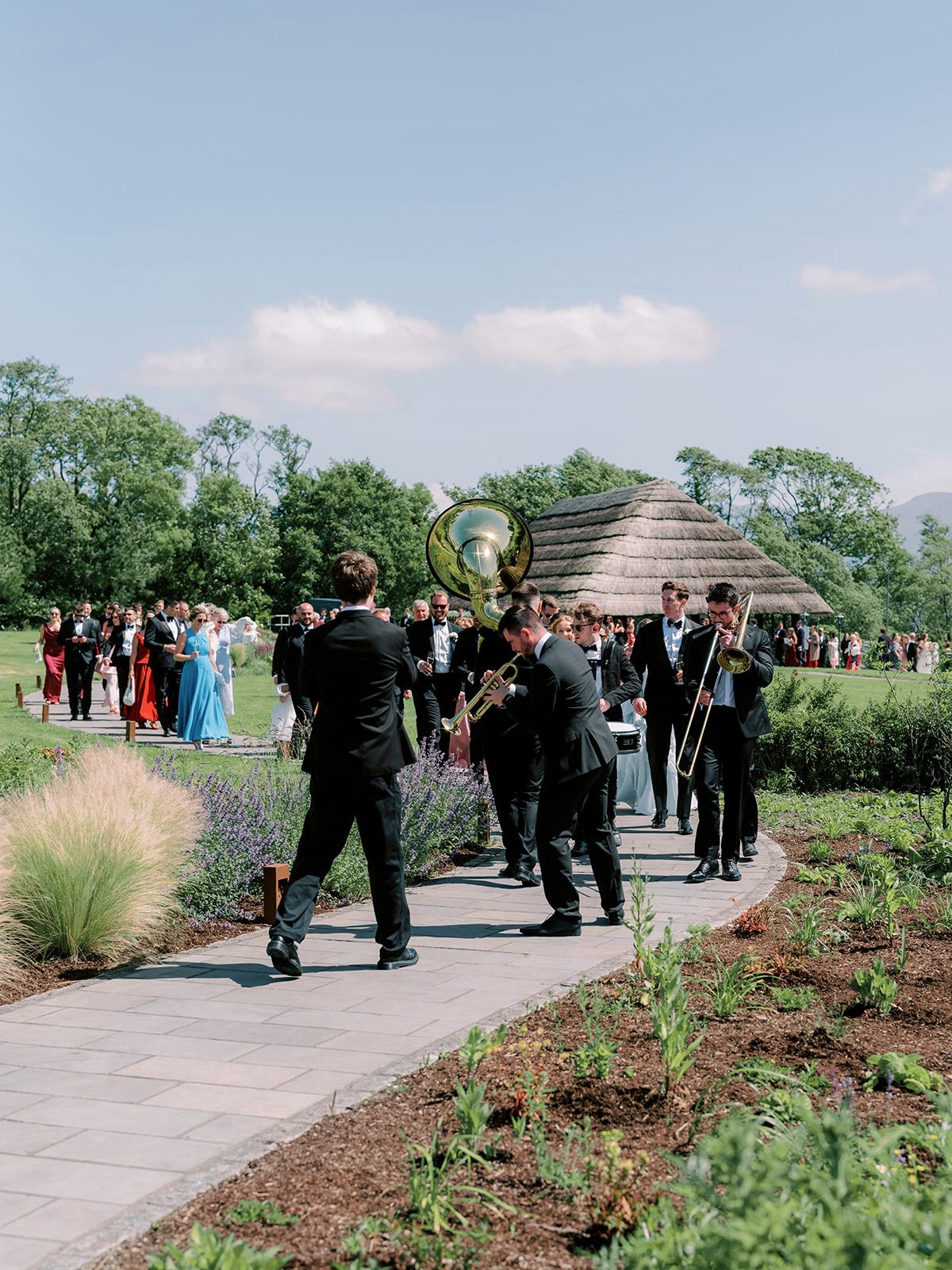 Brasswork leading guests through the gardens